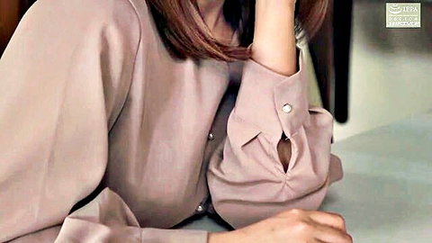 Sexy Japanese mature housewife in pink blouse leaning seductively at office desk