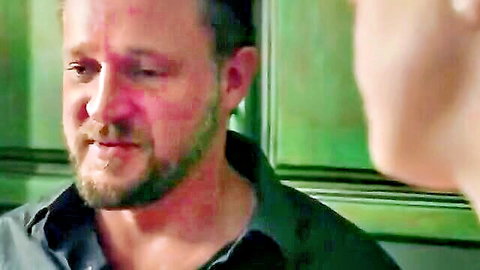 Bearded mature DILF in dark shirt gazes intently at woman in close-up