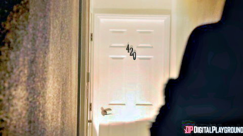 Dark silhouette approaches white door numbered 420 in dimly lit hotel hallway