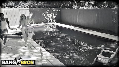 Nude blonde big tits babe walks poolside with black pool cleaners