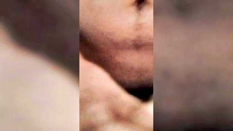 Blurry close-up of woman's face and neck in lesbian porn scene