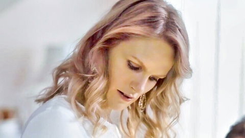 Sophia Heikkilä as thoughtful mother in white blouse, close-up from Hatching (2022)