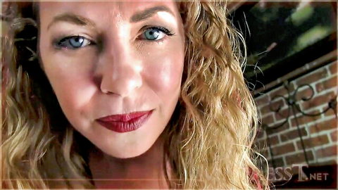 Seductive blonde woman with curly hair, blue eyes, red lips