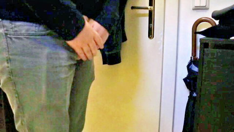 Desperate hunk in jeans holds back pee urge at door, wetting fetish