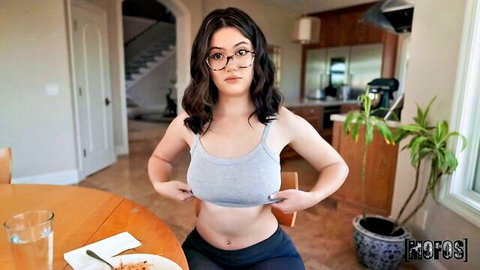 Brunette with glasses teases breasts in tank top, saucy dinner scene with Charles Dera