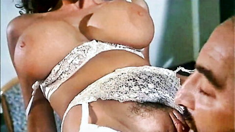 Busty brunette with huge natural tits exposes massive boobs while bearded man licks her pussy closeup