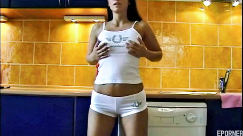 Blonde beauty with big curves teasing in white tank top and shorts
