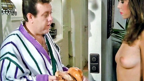 Vintage softcore topless brunette chatting with robed man holding burger