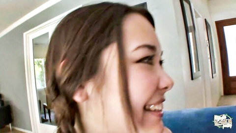 Smiling Asian woman with braided brown hair, side profile close-up