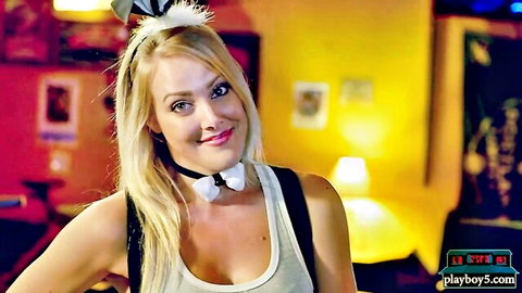 Blonde playboy bunny in femdom fetish comedy show, smiling playfully
