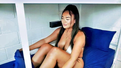 Busty babe in skimpy white bikini teasing big tits and spreading legs on bunk bed