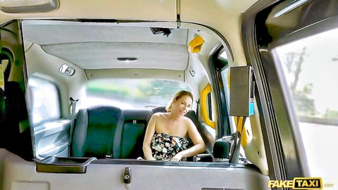 Blonde babe smiling with deep cleavage in floral dress in Fake Taxi backseat