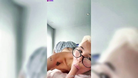 BellaBaby Norwegian blonde sucking dildo with glasses on bed