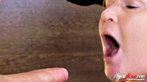 Mature blonde with open mouth in intense oral sex close-up from AgedLove