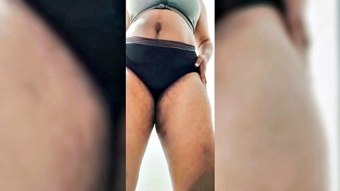 Black thick woman in green bra and black panties showing haunches and butt for worship