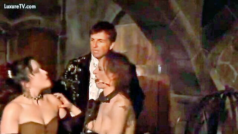 Brunette slave in collar pleasing two masters in BDSM scene