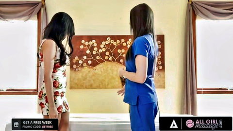 Asian massage therapist in scrubs joins client in floral dress for intimate session