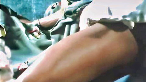 Retro Ribu Film scene: Woman in sheer dress with hand near groin, legs spread