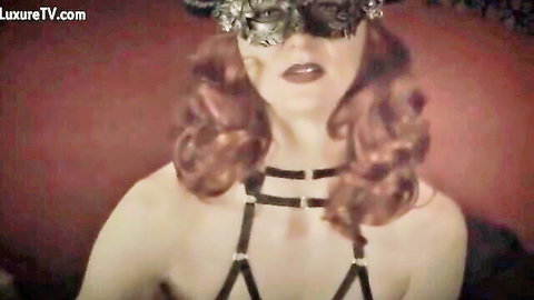 Redhead in black harness and mask, topless dominatrix for pegging