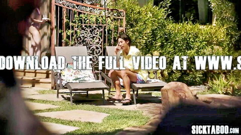 Lexi Luna in yellow top and shorts, lounging with phone outdoors