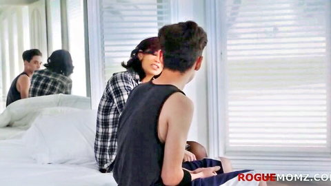 Asian stepmom in plaid shirt seduces young stepson on bed