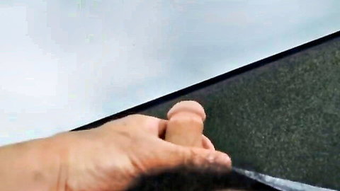 Hairy male hand gripping erect pink cock dildo rubbing against green shag carpet ceiling