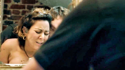 Topless brunette with natural tits grimaces in ecstasy as man fucks her from behind
