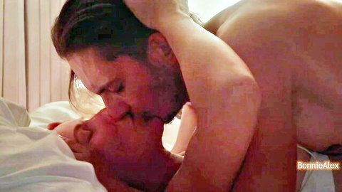 Two muscular men kissing intimately during gay intercourse