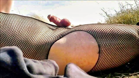 Crossdresser in fishnets wanking and cumming on public beach