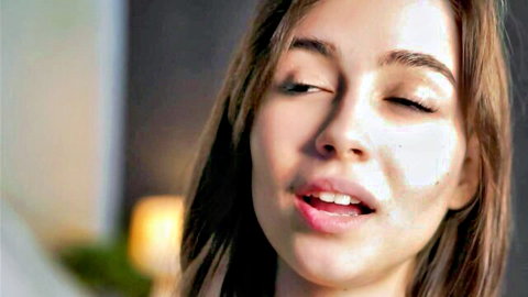 Sexy Asian teen babe teases with glossy open mouth and half-closed eyes on webcam