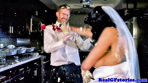 Topless brunette bride with big tits smashes cake on groom's grinning face in kitchen