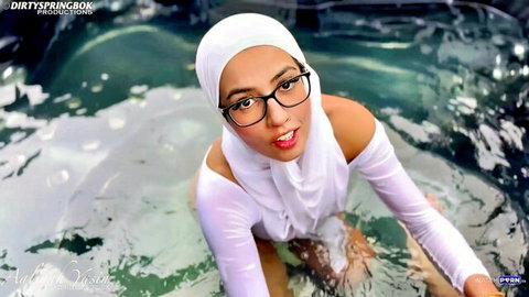 Aaliyah Yasin in wet hijab and glasses, seductive hot tub pose