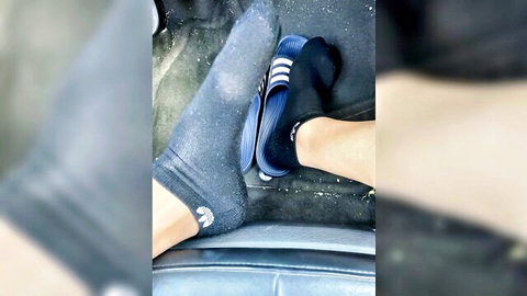 Man's socked feet in blue Adidas flip-flops on car seat, van session