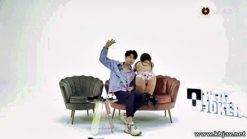 Korean talk show scene with woman showing big ass in thong, man in jacket waving