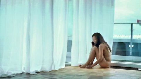 Sabine Timoteo nude sitting thoughtfully by window in Chaos und Stille 2024
