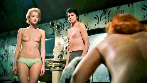 Vintage topless blonde with small tits in panties poses with shirtless man and redhead nude backview