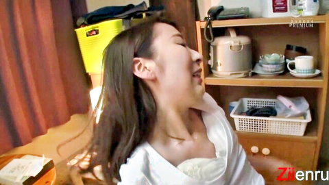 Smiling Asian wife in open white blouse, playful expression during intimate moment