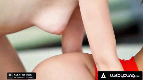 Skinny blonde teen exposes small perky tits in closeup lesbian fingering scene