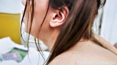 Brunette teen with long hair moans passionately in bedroom closeup