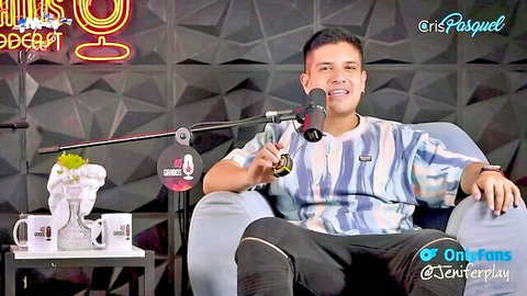 Hispanic man in striped shirt on adult podcast set, OnlyFans promo