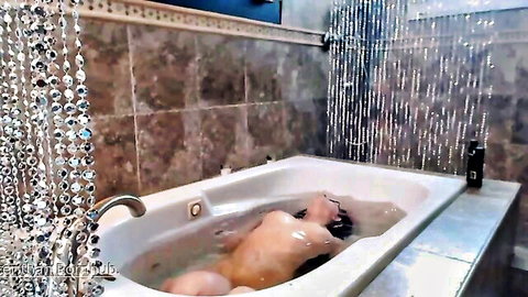 Skinny brunette teen with big natural tits naked in bubbly bathtub exposing perky nipples