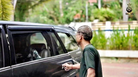 Indian man in green shirt opening car door outdoors, BBW blowjob video preview