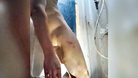 Close-up of man gripping thick erect penis in solo masturbation