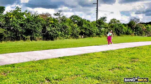 Misty Addams in pink outfit walking outdoors on BangBus