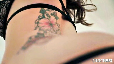 Curvy brunette babe's big ass and pink floral tattoo in black lace lingerie closeup