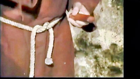 Man's thick erect cock and balls tightly bound with knotted white ropes in BDSM bondage
