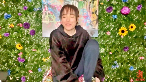 Brooke Johnson smiling eyes closed in black hoodie, Kink studio solo