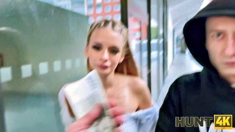 Older guy in hoodie grabs young topless blonde in public hallway