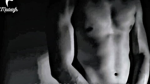 Muscular shirtless hunk flexing ripped abs and pecs in dramatic black and white
