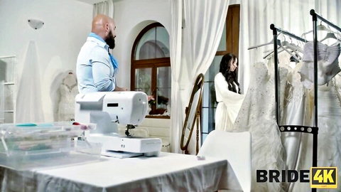 Stunning bride in white gown with partner in bridal atelier intimate moment